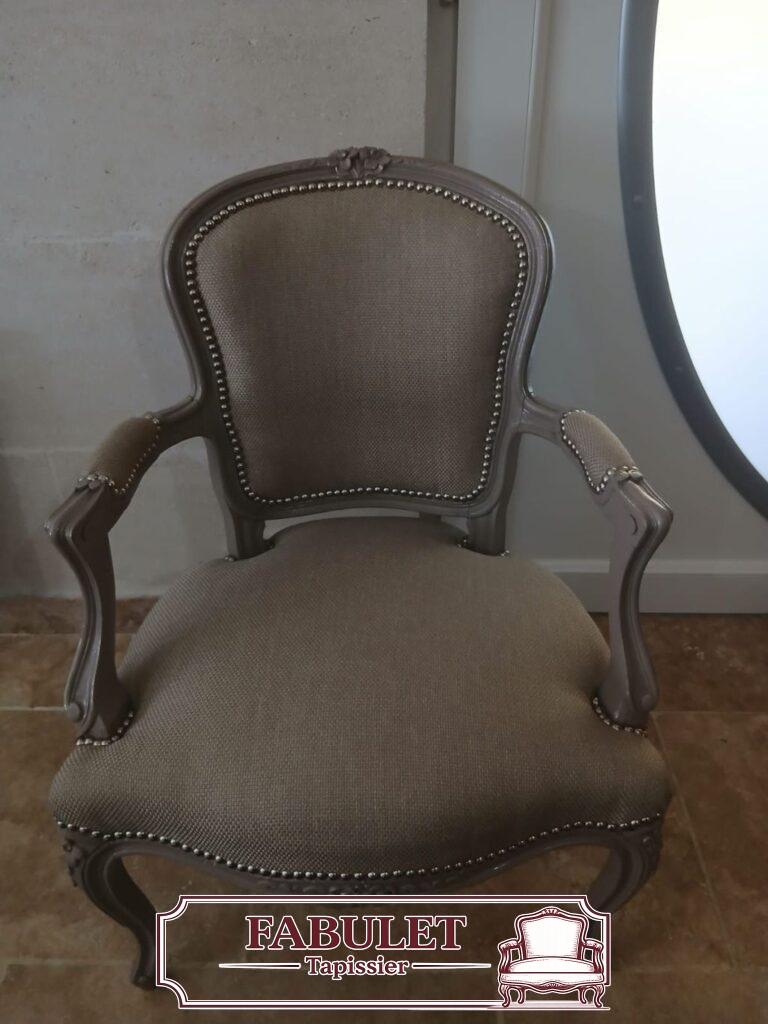 Fauteuil cabriolet Louis XV patiné gris avec tissu taupe et finition cloutée